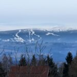 Výhled na zasněžené vrcholky Krkonoš od Panorama Kozákov